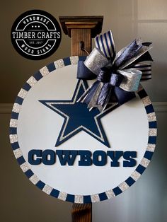 a sign with a star on it that says cowboys in blue and silver glitters