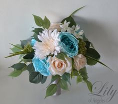 a bridal bouquet with blue, white and pink flowers on it's side