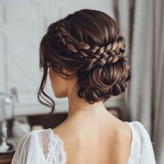 Updos are a classic choice for special occasions, and when combined with goddess styling, they become even more striking. One of the most elegant goddess updos involves intricate braiding that starts at the crown and gathers into a voluminous bun or chignon. Loose tendrils can be left out to soften the look and create a more romantic feel. This hairstyle is ideal for formal events such as weddings, galas, or parties where you want to make a statement. Updos with a goddess twist offer both elegan Wedding Hair Updo Brown Hair, Plait Updo Wedding, Homecoming Hairstyles Red Hair, Romantic Low Updo Wedding, Dark Brown Hair Updo Wedding, Fall Wedding Updos Bridal Hairstyles, Bridesmaid Hairstyles Updo Long Hair, Bridal Hairstyles Braid, Wedding Hair Updo With Braid