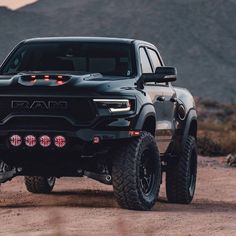 a black truck is parked in the desert