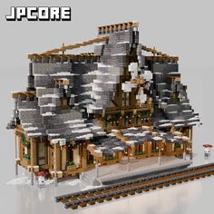 a lego model of a building with lots of windows and roofing on top of train tracks