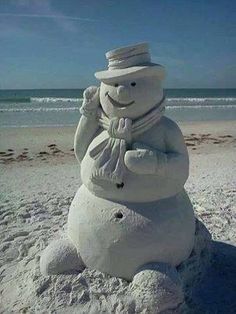 a snowman made to look like it is standing in the sand at the beach