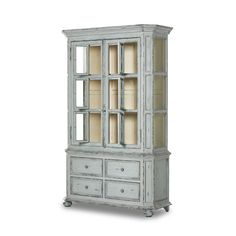 an old white china cabinet with glass doors on the front and drawers in the back