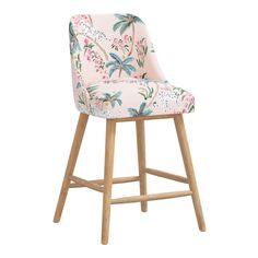 an upholstered pink and blue bar stool with palm trees on the backrest