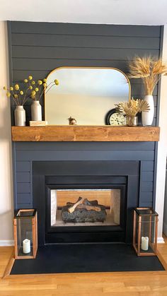 a fireplace with a mirror and candles on it