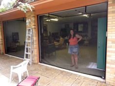 a woman standing in front of an open garage door