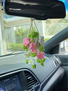 a car dashboard with flowers hanging from the dash board