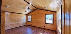 an empty room with wood flooring and ceiling fan