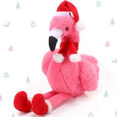 a pink flamingo stuffed animal with a santa hat on it's head and feet