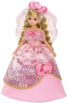 the doll is wearing a pink dress with flowers on her head and veil over her head