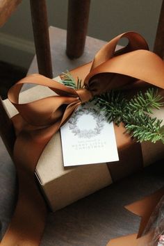 a wrapped present sitting on top of a wooden chair