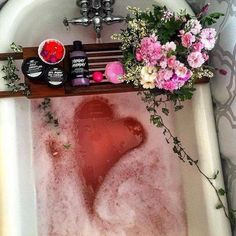 a bathtub filled with soap and flowers