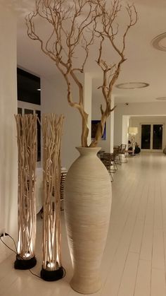 two large vases sitting on top of a white floor next to each other in a room