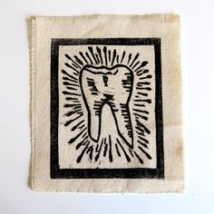 a tooth on a piece of cloth with black and white ink