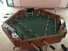 a foosball table with several pieces of equipment on it in a living room