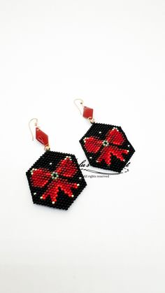 red and black beaded earrings on white background