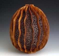 a wooden vase with an animal print design on it