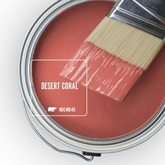 a paint can with a red pepper on it and a brush in the top right corner