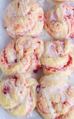 a white plate topped with pastries covered in icing