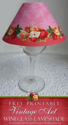 a pink lamp shade sitting on top of a white doily covered table next to a red sign that says free printable vintage art wine glass lampshade