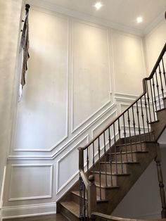 a stair case in an empty room with white walls