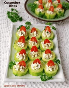 cucumber bites with tomatoes and cream cheese on them are ready to be eaten