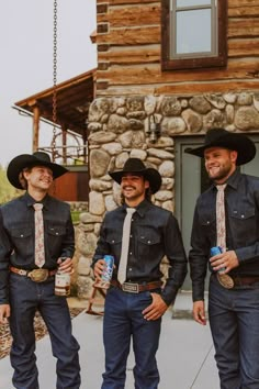 three men wearing cowboy hats and ties standing next to each other in front of a building