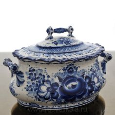 a blue and white covered pot sitting on top of a table