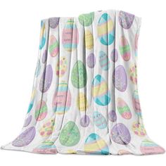 an image of a blanket with easter eggs on the back and white fabric around it