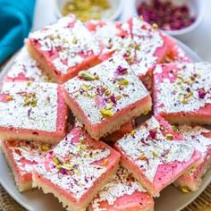 there are many pieces of cake on the plate and one piece has been cut into squares