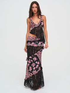 Featured in a pink and black floral print, the Rosalyn Maxi Skirt has a distinctly vintage feel. Featuring ruffles, pintucks, and lace paneling throughout, you can match it to the Rosalyn Crop Top for a summer-ready skirt set that captivates. Floral Midi Skirt Outfit, Floral Maxi Skirt Outfit, Matching Skirt And Top Set, Midi Skirt Outfits Summer, Knitted Outfits For Women, Crop Tops Long Sleeve, Matching Top And Skirt, Frock And Frill, Vintage Maxi Skirt