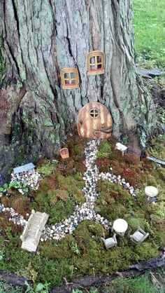 a fairy tree house made out of rocks and moss