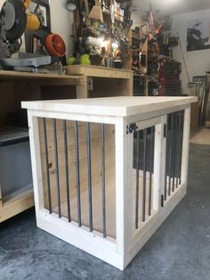 a wooden dog crate with bars on the front and sides, in a shop area