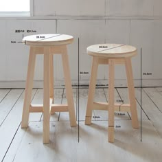 two wooden stools with measurements for each seat and the height in front of them