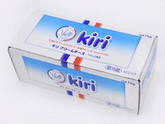 two boxes of kiri toothpaste sitting side by side on a white surface