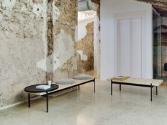 a living room filled with furniture next to a wall covered in peeling paint on the walls