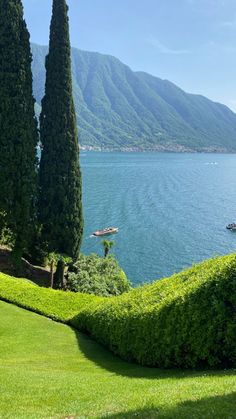 an image of a beautiful view of the water and trees in the foreground with mountains in the background