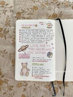 an open notebook with writing on it and a teddy bear in the corner next to it