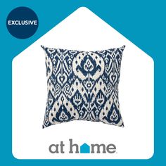 a blue and white pillow with the words at home on it in front of an image of