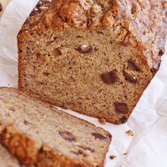 a loaf of banana bread sitting on top of a piece of wax paper