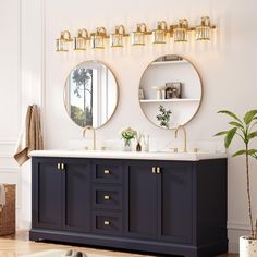 a bathroom with two round mirrors above the sinks and gold fixtures on the wall behind it