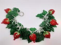 I love  strawberries This just screams Summer to me. These strawberry charms are heavier,  so that will make the bracelet heavier.  Made with bling charms, acrylic charms, and silver tone materials.  I have  matching earrings listed too. Be sure to check out my other items too. I have amazing deals in my CLEARANCE EARRINGS section! Check them out. Fun Nickel-free Metal Jewelry, Novelty Dangle Charms Jewelry, Fun Silver Metal Jewelry, Novelty Red Resin Jewelry, Red Resin Novelty Jewelry, Novelty Dangle Jewelry With Charms, Novelty Jewelry With Dangling Charms, Novelty Resin Dangle Jewelry, Whimsical Silver Resin Jewelry