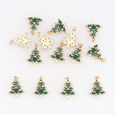 twelve christmas tree charms in various shapes and sizes