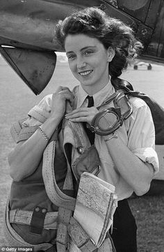 black and white photograph of a woman in front of an airplane with her backpack on