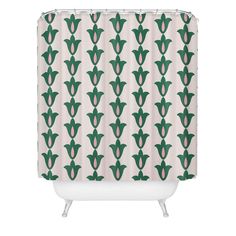 a green and white shower curtain with an abstract flower pattern on the bottom, in front of a white background