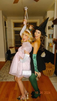 two women dressed up as witches posing for the camera