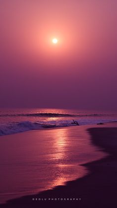 the sun is setting over the ocean with waves