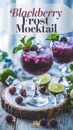 two glasses filled with blackberry frosted cocktail on top of a wooden table next to limes