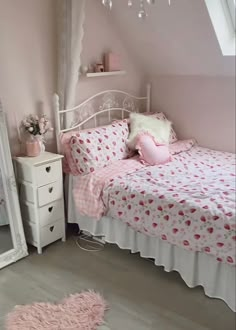 a bedroom with pink walls and white furniture