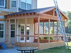 a house being built in the yard with a ladder